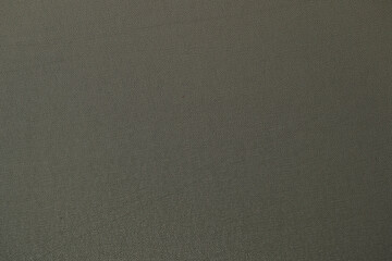 Dark gray fabric background closeup. Abstract gray background