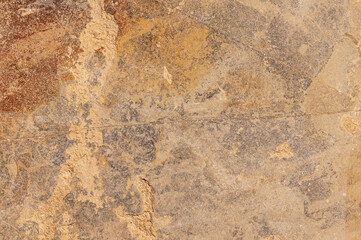 Textured stone sand colored background of real old stone. Stone wall of real stone with patterns and spots.