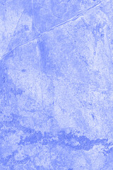 Textured purple stone background with real patterns of spots and scratches. Natural stone wall of purple or blue color.