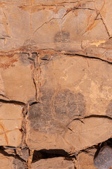 Textured stone background with real scratches and spots. Old stone wall is sand colored.