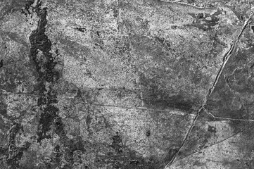 Textured natural stone background of gray color with black and white spots. Old stone wall is grey.