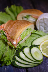 croissant with salmon, lettuce and fresh cucumber
