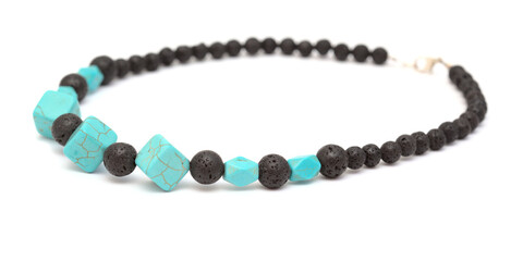 Holiday jewelry - simple necklace made of black porous volcanic beads isolated on white background 