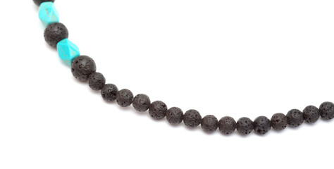 Holiday jewelry - simple necklace made of black porous volcanic beads isolated on white background 