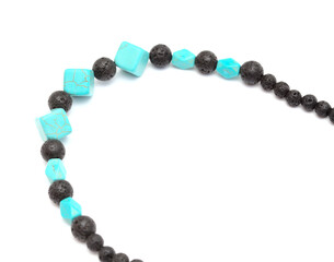 Holiday jewelry - simple necklace made of black porous volcanic beads isolated on white background 