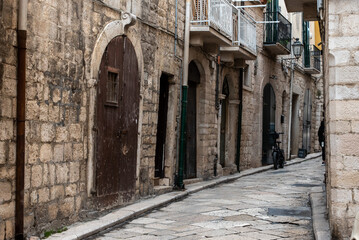 Fototapeta na wymiar An abandoned narrow and stony alleyway in downtown Bari, Southern Italy