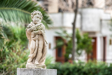 Obraz premium Baroque sculpture of a child in a park in Trani, Italy
