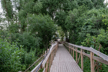 bridge construction site over small river in Latvia. Temporary wooden pedestrian bridge over the river