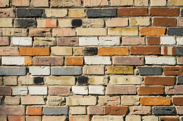 Obraz premium Multi-colored brickwork, stone building wall
