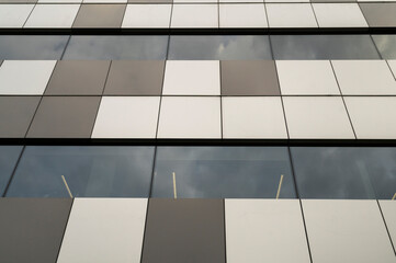 metal panels on the facade of a modern building with windows