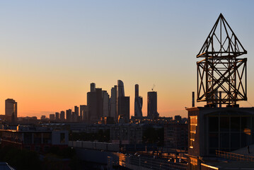 Downtown Moscow at Sunset. Radio antenna in the foreground.