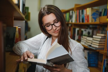 Education, high school, university, learning and people concept. Smiling student girl reading book