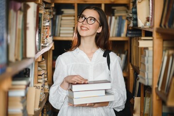 Portrait of a beautiful student in a library