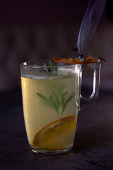 hot drink cocktail with a sprig of rosemary and lemon