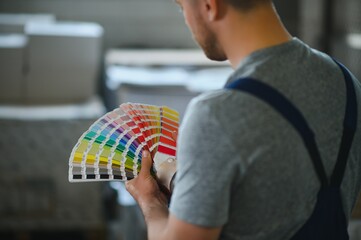 Printing house. The printer works in a modern production hall.