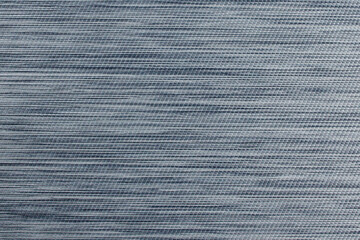 Gray fabric background from textile dense material with wicker pattern, close up. Fabric structure. Fabric background