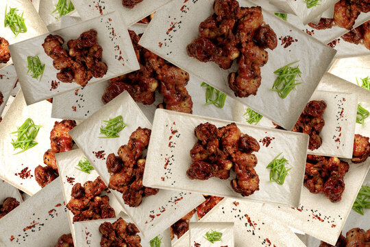 Grilled chicken legs in sauce on a light plate, pattern