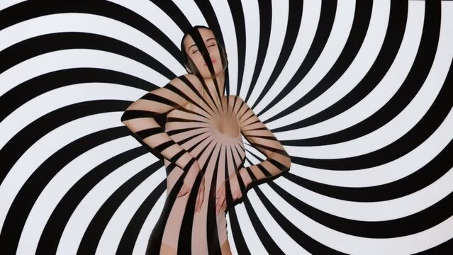 Cute sexy model in bodysuit posing dancing seductively she moves slowly and elegantly overlay black and white animated stripes motion background illuminated with projector. Female on hypnotic backdrop