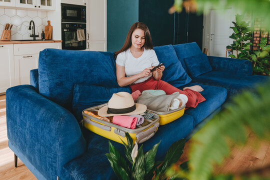 Beautiful young woman holding blank craft paper packet