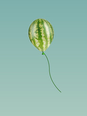 Watermelon balloon floating on pastel blue background. Funny summer concept. Food and fruit concept. Minimal idea creative concept.