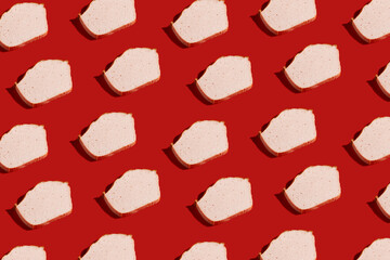 hard light pattern of a slice of traditional oven baked bavarian meal leberkäse - meat dish made of corned beef, pork and bacon, finely ground and baked as a bread loaf, red background