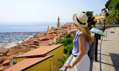 Holidays on French Riviera. Beautiful fashion girl enjoying view of Menton town on French Riviera....