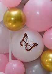 Background of pink and white balloons. butterflies
