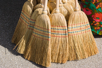 Straw broomsticks for sale outdoors