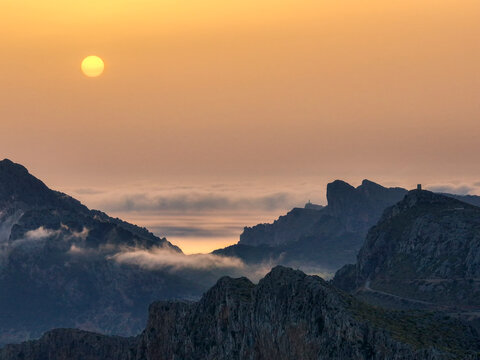 Aerial image of golden hour sunrise with clouds and fog on Cap de Formentor, Mallorca, Spain