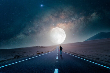 road to the moon in the desert at night with silhouette of a person - obrazy, fototapety, plakaty