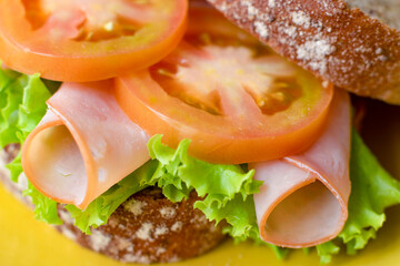 Wholemeal bread sandwich with ham, lettuce and tomato, healthy.