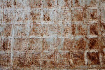 Rusted, old iron door with peeling white paint.