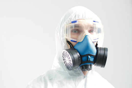 Man in protective suit goggles and respirator