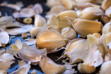 Unpeeled cloves of garlic on a kitchen counter top