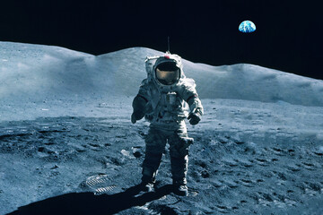 Astronaut on the moon, with the Earth in the background. Elements of this image furnished by NASA