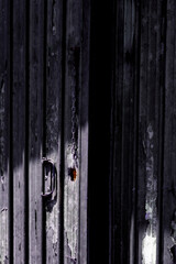 Dark grunge door of an abandoned shed  left ajar