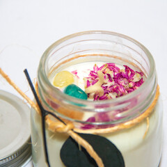 scented candles in glass jar with decorative elements
