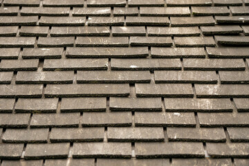 Wooden roof tiles. Old and weathered material.