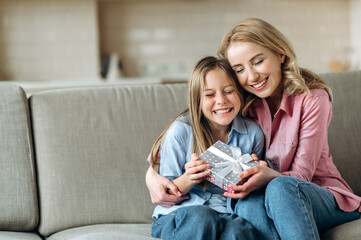 Happy mom with her daughter. Lovely daughter gave her beloved mother a gift for mother's day or...