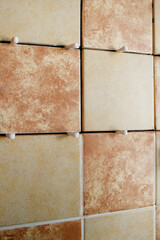 Laying ceramic tiles with the help of crosses for a tile by during wall cladding