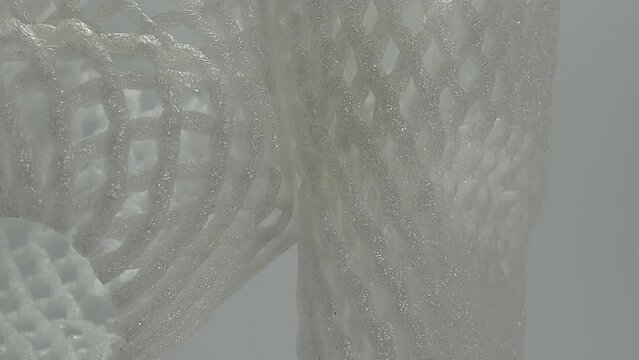 white foam basket. white foam net for fruit wrapping. roll up mesh foam container for apples, pears, vegetables, eggs and more on a white background
