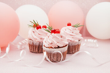 Strawberry pink cupcakes on glitter background with air balloons, card with celebration concept