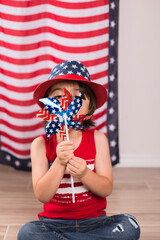 child wearing 4th of july clothes and hat celebrating studio photo copy space 