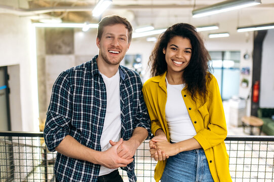 Portrait Of Business Coworkers Or Student Friends. Handsome Caucasian Man And Beautiful African American Woman Work Or Study Together, Colleagues Look At The Camera, Smiling