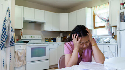 Stressed young asian woman unemployed reading paper pay bills , feeling frustrated of getting eviction letter or bank debt notification, thinking of financial problems. concept unemployed pay bills. - obrazy, fototapety, plakaty