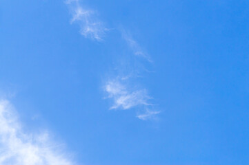 Beautiful blue sky texture with little strange white cloud and clear light under shining from the sun for background