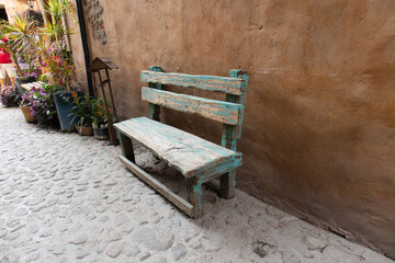 Fototapeta na wymiar old wooden public seat in a medieval italian tuscany villa