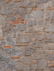 texture of a brick and stone combined wall in a medieval italian tuscany villa