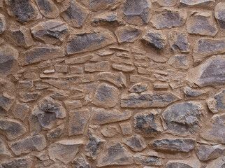 texture of a brick and stone combined wall in a medieval italian tuscany villa