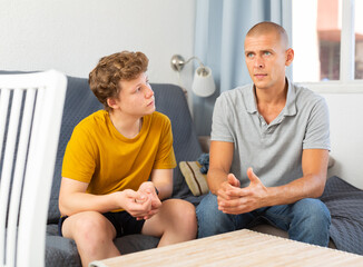 Father and his young son spending time at home together